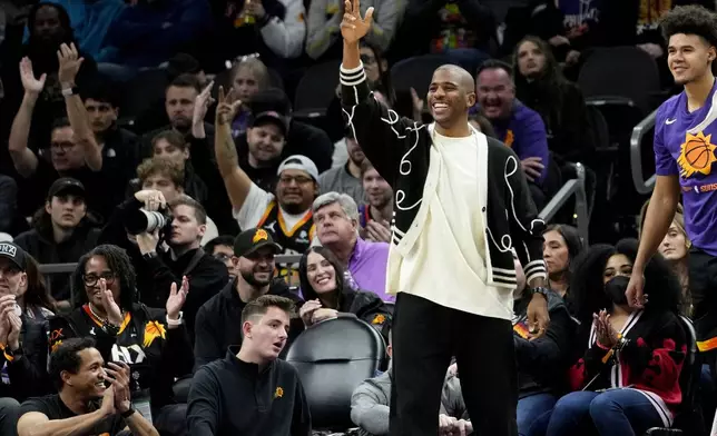 FILE - Phoenix Suns guard Chris Paul celebrates from the bench against the Brooklyn Nets during the first half of an NBA basketball game, Thursday, Jan. 19, 2023, in Phoenix. (AP Photo/Matt York, File)