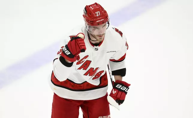 Carolina Hurricanes right wing Andrei Svechnikov (37) celebrates his goal as he skates to the bench in the third period of Game 5 of a second-round NHL hockey playoff series against the Washington Capitals Thursday, May 15, 2025, in Washington. (AP Photo/Nick Wass)