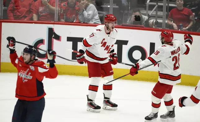Carolina Hurricanes right wing Andrei Svechnikov (37) celebrates his goal with defenseman Sean Walker (26) in the third period of Game 5 of a second-round NHL hockey playoff series against the Washington Capitals Thursday, May 15, 2025, in Washington. (AP Photo/Nick Wass)