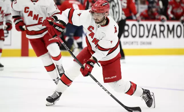 Carolina Hurricanes defenseman Shayne Gostisbehere (4) shoots the puck in the second period of Game 5 of a second-round NHL hockey playoff series against the Washington Capitals Thursday, May 15, 2025, in Washington. (AP Photo/Nick Wass)
