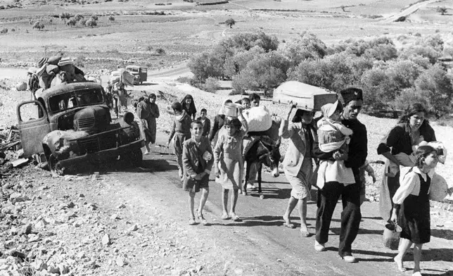 FILE - Palestinian villagers flee during fighting between Israeli and Arab troops on Nov. 4, 1948. (AP Photo/Jim Pringle, File)