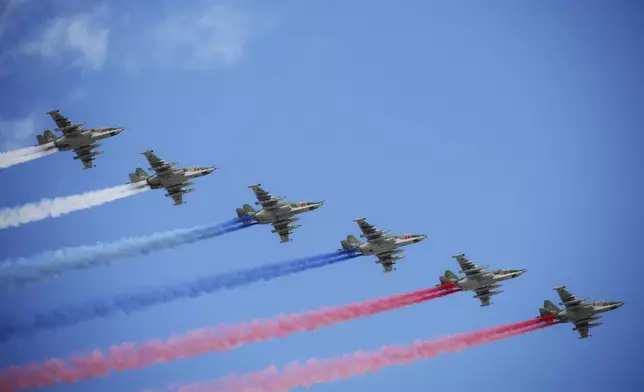 Russian Air Force Su-25 jets fly over Red Square leaving trails of smoke in the colors of the Russian state flag during the Victory Day military parade in Moscow, Russia, Friday, May 9, 2025, during celebrations of the 80th anniversary of the Soviet Union's victory over Nazi Germany during the World War II. (Vladimir Astapkovich/Photo host agency RIA Novosti via AP)