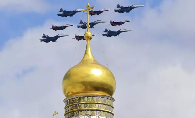 Russian Sukhoi Su-30SM jet fighters of the Russian Knights aerobatic team and Mikoyan MiG-29 jet fighters of the Swifts aerobatic team fly over the Red Square during the Victory Day military parade in Moscow, Russia, Friday, May 9, 2025, for celebrations of the 80th anniversary of the Soviet Union's victory over Nazi Germany during the World War II. (Pavel Lisitsyn/Photo host agency RIA Novosti via AP)