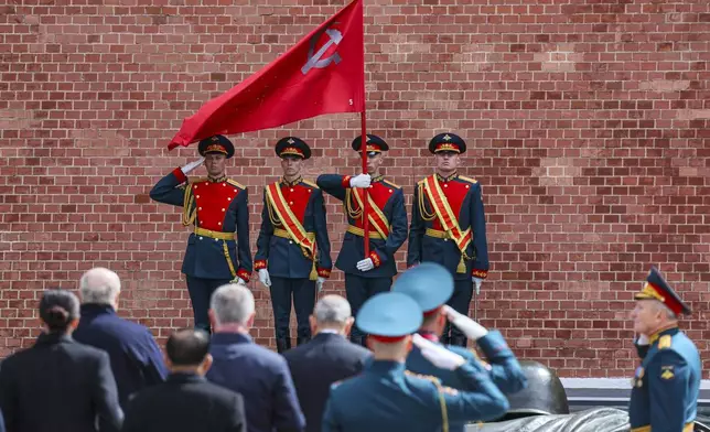 The Kremlin guards attend a wreath laying ceremony at the Tomb of the Unknown Soldier in Alexander Garden after the Victory Day military parade in Moscow, Russia, Friday, May 9, 2025, during celebrations of the 80th anniversary of the Soviet Union's victory over Nazi Germany during the World War II. (Yuri Kochetkov/Pool Photo via AP)