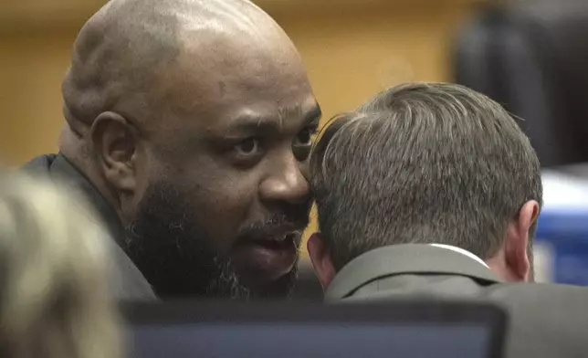 Cleophus Cooksey Jr., left, who is accused of killing eight people over a three-week span in late 2017, talks with attorney Adrian Little during his trial in Maricopa County Superior Court, Monday, May 5, 2025, in Phoenix. (Mark Henle/The Arizona Republic via AP, Pool)