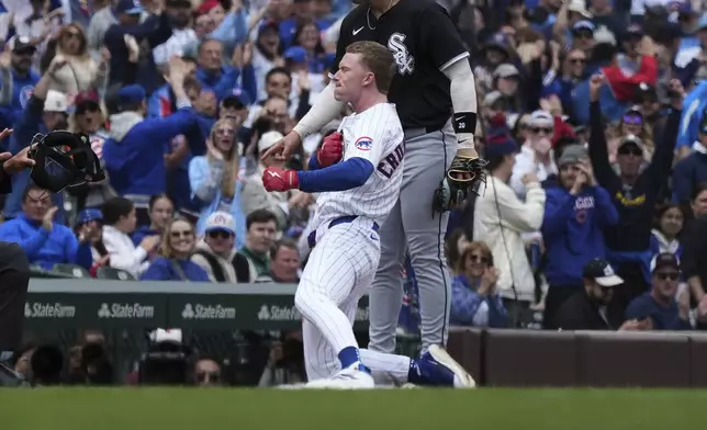 Chicago Cubs' Pete Crow-Armstrong, center front, celebrates after hitting a triple during the first inning of a baseball game against the Chicago White Sox in Chicago, Sunday, May 18, 2025. (AP Photo/Nam Y. Huh)