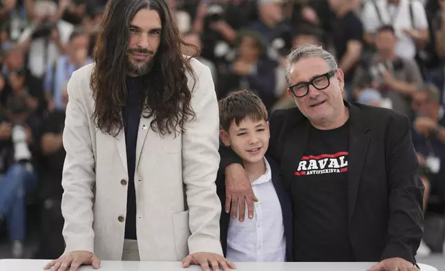 Director Oliver Laxe, from left, Bruno Nunez, and Sergi Lopez pose for photographers at the photo call for the film 'Sirat' at the 78th international film festival, Cannes, southern France, Friday, May 16, 2025. (Photo by Lewis Joly/Invision/AP)