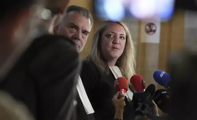 Franck Berton, left, and Chloe Arnaux, lawyers for Aomar Aït Khedache, one of the men accused in the 2016 armed robbery of Kim Kardashian, answer reporters after the verdict in the trial of Kim Kadashian heist, Friday, May 23, 2025 in Paris. (AP Photo/Christophe Ena)