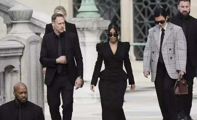 Kim Kardashian, center, accompanied by her mother Kris Jenner, second right, leaves the justice palace after testifying, regarding a robbery of millions of dollars in jewels from her Paris hotel room in 2016, in Paris, Tuesday, May 13, 2025. (AP Photo/Aurelien Morissard)