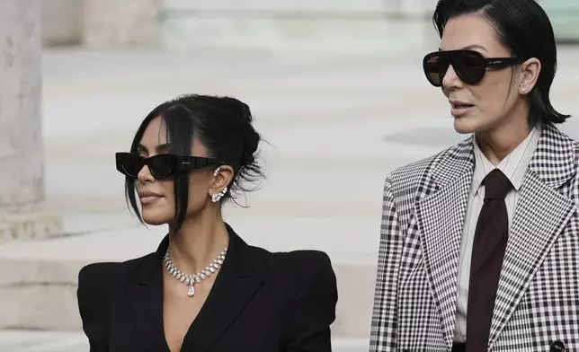 Kim Kardashian, left, accompanied by her mother Kris Jenner leaves the justice palace after testifying, regarding a robbery of millions of dollars in jewels from her Paris hotel room in 2016, in Paris, Tuesday, May 13, 2025. (AP Photo/Aurelien Morissard)
