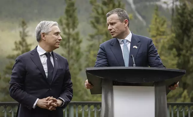 Ukraine Minister of Finance, Sergii Marchenko, right, and Canada's Finance Minister Francois-Philippe Champagne speak to the media prior to the G7 Finance Ministers meeting in Banff, Alberta, Tuesday, May 20, 2025. (Jeff McIntosh/The Canadian Press via AP)