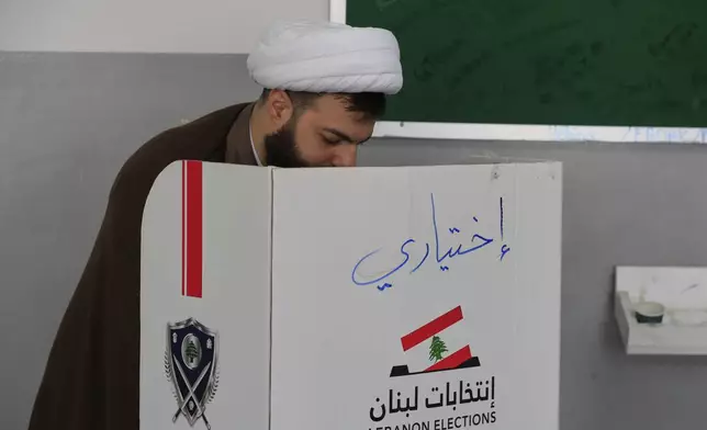 A Shiite cleric casts his ballot at a polling station during municipal elections in the town of Nabatieh, south Lebanon, Saturday, May 24, 2025. (AP Photo/Mohammed Zaatari)