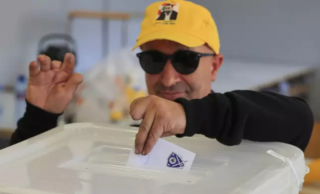 A Hezbollah member who was wounded during Sept. 17, 2024 pager explosions, casts his vote at a polling station during municipal elections in the town of Nabatieh, south Lebanon, Saturday, May 24, 2025. (AP Photo/Mohammed Zaatari)