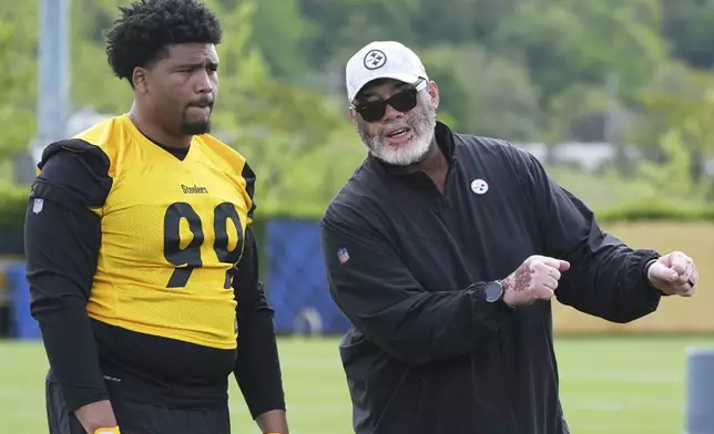 Pittsburgh Steelers first round draft pick Derrick Harmon (99) listens as defensive line coach Karl Dunbar explains a drill during the NFL football team's rookie camp in Pittsburgh, Friday, May 9, 2025. (AP Photo/Gene J. Puskar)