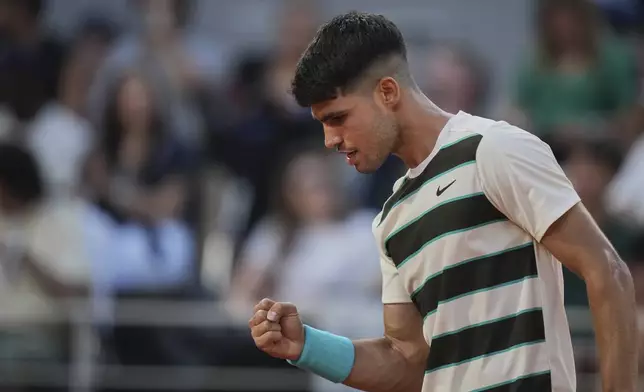 Spain's Carlos Alcaraz reacts during a third round match against Bosnia and Herzegovina's Damir Dzumhur at the French Open tennis tournament at the Roland-Garros stadium, Friday, May 30, 2025, in Paris. (AP Photo/Thibault Camus)