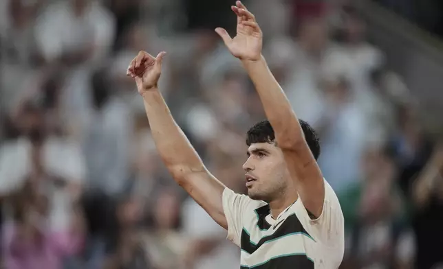 Spain's Carlos Alcaraz celebrates after defeating Bosnia and Herzegovina's Damir Dzumhur during their third-round match of the French Tennis Open at the Roland-Garros stadium in Paris, Friday, May 30, 2025. (AP Photo/Thibault Camus)