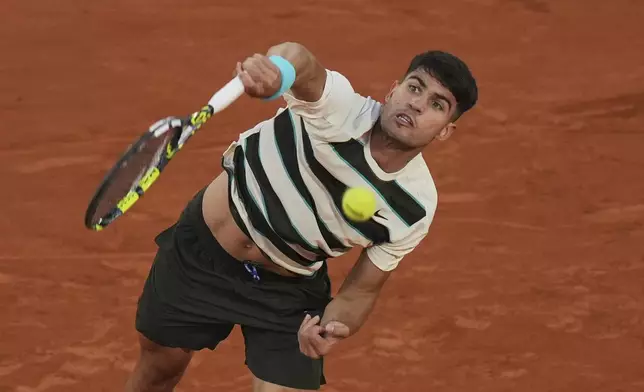 Spain's Carlos Alcaraz serves to Bosnia and Herzegovina's Damir Dzumhur during their third round match at the French Open tennis tournament at the Roland-Garros stadium, Friday, May 30, 2025, in Paris. (AP Photo/Thibault Camus)
