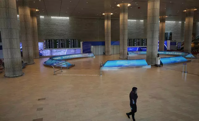 Israel's Ben Gurion Airport is empty of passengers after all flights were canceled following an Israeli military strike on Iran, near Tel Aviv, Israel, Friday, June 13, 2025. (AP Photo/Ariel Schalit)