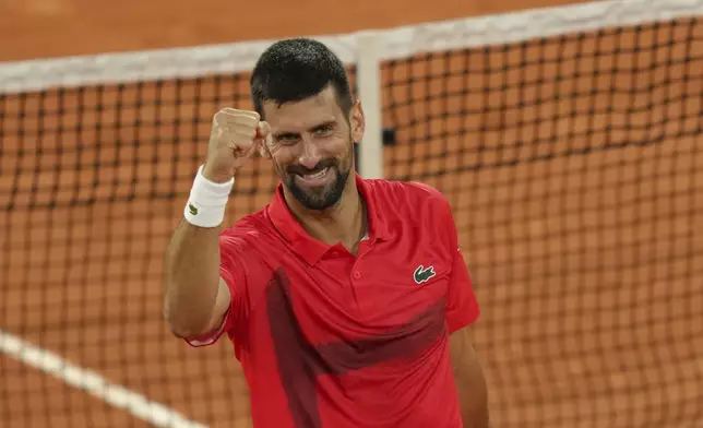 Serbia's Novak Djokovic celebrates as he won the quarterfinal match of the French Tennis Open against Germany's Alexander Zverev at the Roland-Garros stadium in Paris, Wednesday, June 4, 2025. (AP Photo/Aurelien Morissard)