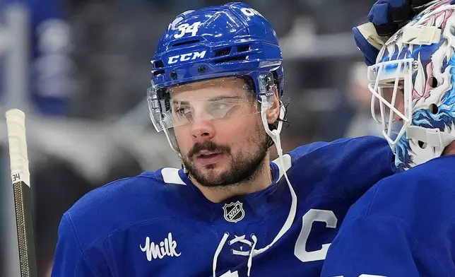 FILE - Toronto Maple Leafs centre Auston Matthews (34) consoles teammate Joseph Woll (60) in the final moments of the third period of Game 7 of a second-round NHL hockey playoff series in Toronto, May 18, 2025. (Frank Gunn/The Canadian Press via AP, File)