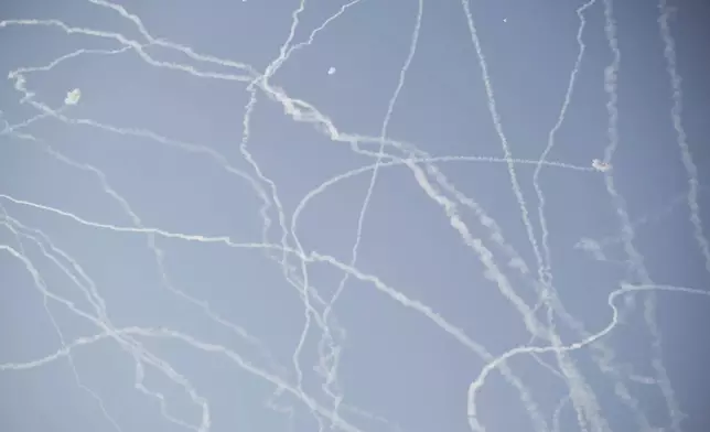 FILE - Israeli air defense system fires to intercept missiles during an Iranian attack over Tel Aviv, Israel, Thursday, June 19, 2025. (AP Photo/Leo Correa, File)