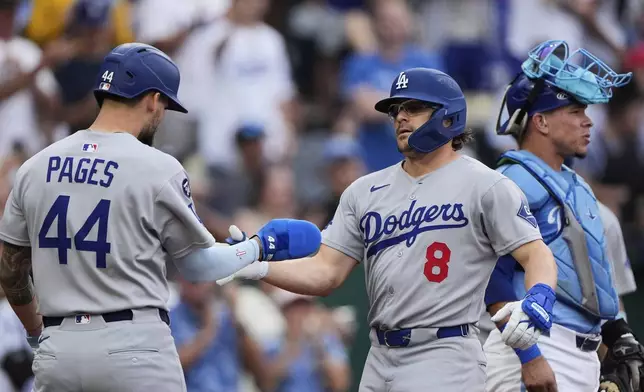 Los Angeles Dodgers' Kike Hernandez (8) celebrates with Andy Pages (44) after hitting a two-run home run during the second inning of a baseball game against the Kansas City Royals, Sunday, June 29, 2025, in Kansas City, Mo. (AP Photo/Charlie Riedel)