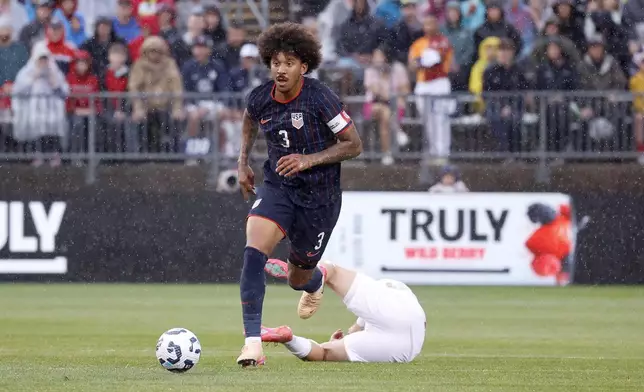 United States defender Chris Richards (3) dribble the ball up the field past a fallen Turkey defender during the first half of an international friendly soccer game, Saturday, June 7, 2025, in East Hartford, Conn. (AP Photo/Mary Schwalm)