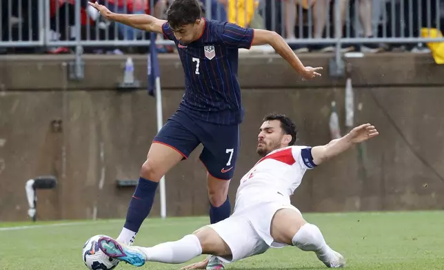 Turkey's Kaan Ayhan slides to kick the ball away from United States midfielder Quinn Sullivan (7) during the second half of an international friendly soccer game, Saturday, June 7, 2025, in East Hartford, Conn. (AP Photo/Mary Schwalm)