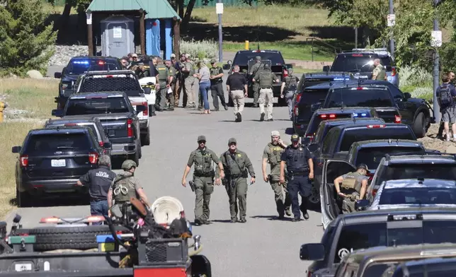 Law enforcement and emergency responders at Cherry Hill Park off 15th Street on Sunday afternoon, June 29, 2025, following reports of an ambush shooting attack on Canfield Mountain, in Coeur d'Alene, Idaho. (Bill Buley/Coeur D'Alene Press via AP)