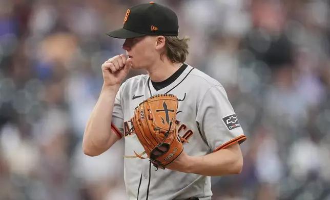 San Francisco Giants starting pitcher Hayden Birdsong reacts after giving up a solo home run to Colorado Rockies' Mickey Moniak in the sixth inning of a baseball game, Thursday, June 12, 2025, in Denver. (AP Photo/David Zalubowski)