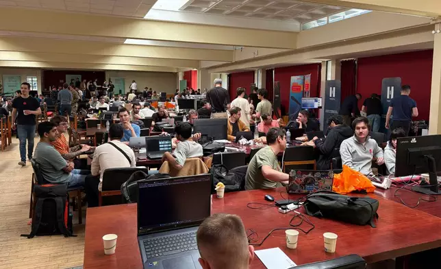 Participants gather for the London Defence Tech Hackathon, a weekend brainstorming solution for technical challenges, at the Royal Military Academy Sandhurst in Camberley, England, May 10, 2025. (AP Photos/Kelvin Chan)