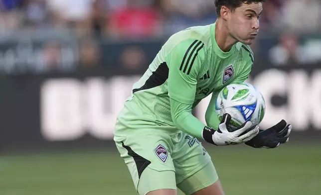 Colorado Rapids goalkeeper Nico Hansen stops a shot by Orlando City in the first half of an MLS soccer match Saturday, June 14, 2025, in Commerce City, Colo. (AP Photo/David Zalubowski)