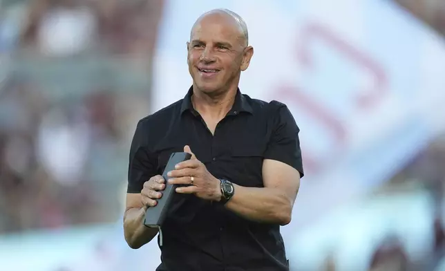Colorado Rapids head coach Chris Armas greets fans as he steps onto the pitch in the first half of an MLS soccer match against Orlando City, Saturday, June 14, 2025, in Commerce City, Colo. (AP Photo/David Zalubowski)