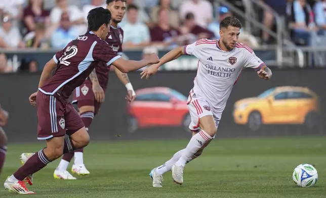 Colorado Rapids midfielder Josh Atencio, front left, pursues the ball with Orlando City forward Marco Pašalić, right, in the first half of an MLS soccer match Saturday, June 14, 2025, in Commerce City, Colo. (AP Photo/David Zalubowski)