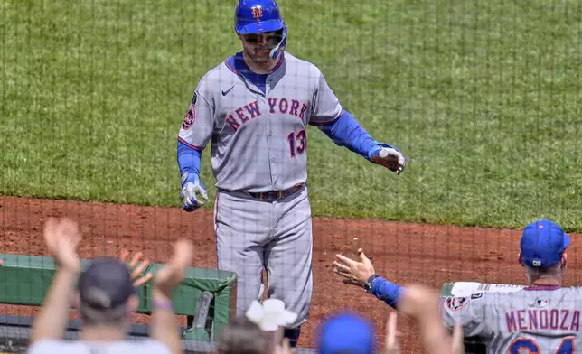 New York Mets' Luis Torrens (13) returns to the dugout after hitting a solo home run off Pittsburgh Pirates pitcher Mike Burrows during the fifth inning of a baseball game in Pittsburgh, Sunday, June 29, 2025. (AP Photo/Gene J. Puskar)