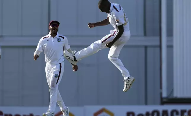 West Indies' Brandon King, left, celebrates with teammate Justin Greaves the dismissal of Australia's Cameron Green on day two of the first cricket Test match at Kensington Stadium in Bridgetown, Barbados, Thursday, June 26, 2025. (AP Photo/Ricardo Mazalan)