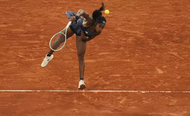 Coco Gauff of the U.S. serves against France's Lois Boisson during their semifinal match of the French Tennis Open at the Roland-Garros stadium in Paris, Thursday, June 5, 2025. (AP Photo/Thibault Camus)
