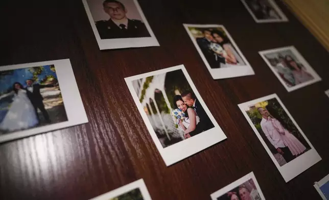 Family photos of Olha Kurtmalaieva and her husband Ruslan are seen at their apartment in Kyiv, Ukraine, on Tuesday, June 17, 2025. (AP Photo/Evgeniy Maloletka)