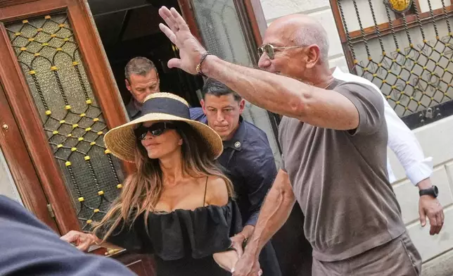 Lauren Sanchez Bezos and Jeff Bezos leave the Harry's Bar in Venice, Italy, Saturday,June 28, 2025, the day after their wedding. (AP Photo/Luca Bruno)