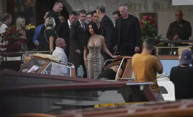 Kim Kardashian, center, leaves a hotel for the pre wedding reception of Amazon founder Jeff Bezos and Lauren Sanchez, in Venice, Italy, Thursday, June 26, 2025. (AP Photo/Antonio Calanni)