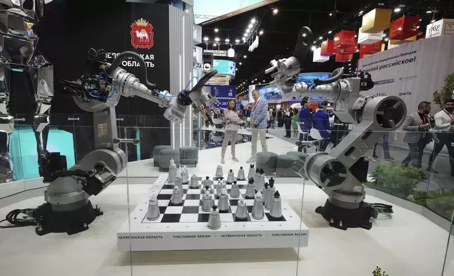 Visitors look at an exhibition on the sidelines of the St. Petersburg International Economic Forum in St. Petersburg, Russia, Wednesday, June 18, 2025. (AP Photo/Dmitri Lovetsky)