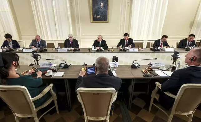 Russian President Vladimir Putin, center, meets with the heads of international news agencies at the newly renovated St. Petersburg Rimsky-Korsakov State Conservatory on the sidelines of the St. Petersburg International Economic Forum in St. Petersburg, Russia, Wednesday, June 18, 2025. (Vyacheslav Prokofyev, Sputnik, Kremlin Pool Photo via AP)