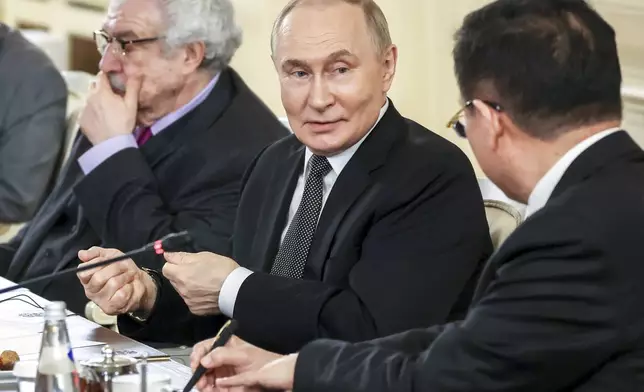 Russian President Vladimir Putin, center, speaks with Xinhua News Agency President Fu Hua, right, during his meeting with the heads of international news agencies at the newly renovated St. Petersburg Rimsky-Korsakov State Conservatory on the sidelines of the St. Petersburg International Economic Forum in St. Petersburg, Russia, Thursday, June 19, 2025. (Vyacheslav Prokofyev, Sputnik, Kremlin Pool Photo via AP)