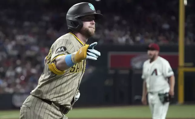 San Diego Padres' Jake Cronenworth celebrates after hitting a two-run home run against the Arizona Diamondbacks in the fourth inning during a baseball game, Sunday, June 15, 2025, in Phoenix. (AP Photo/Rick Scuteri)