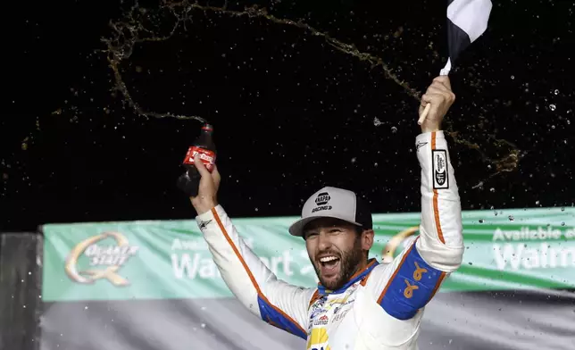 Driver Chase Elliott celebrates in Victory Lane after winning a NASCAR Cup Series auto race, Saturday, June 28, 2025, in Hampton, Ga. (AP Photo/Butch Dill)