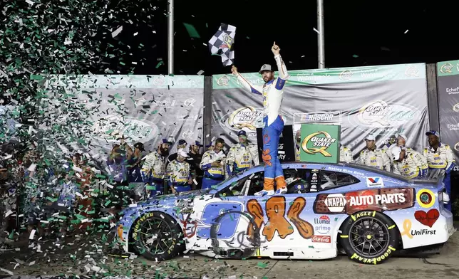 Driver Chase Elliott (9) celebrates in Victory Lane after winning a NASCAR Cup Series auto race, Saturday, June 28, 2025, in Hampton, Ga. (AP Photo/Butch Dill)