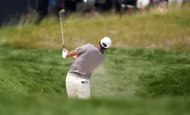 Scottie Scheffler hits from a bunker on the sixth hole during the first round of the U.S. Open golf tournament at Oakmont Country Club Thursday, June 12, 2025, in Oakmont, Pa. (AP Photo/Charlie Riedel)