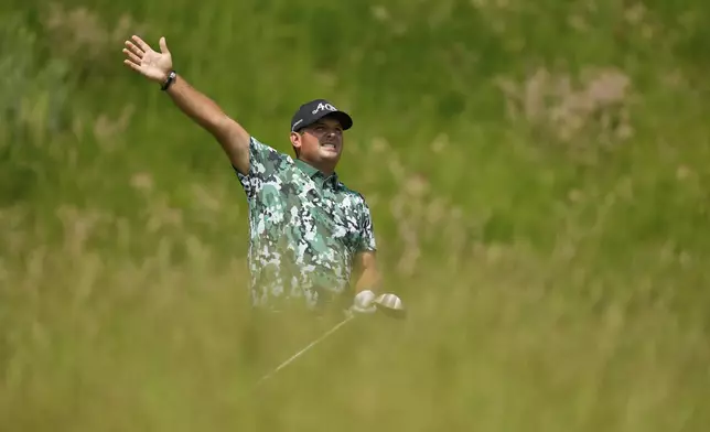 Patrick Reed signals his tee shot is right on the seventh tee during the first round of the U.S. Open golf tournament at Oakmont Country Club Thursday, June 12, 2025, in Oakmont, Pa. (AP Photo/Charlie Riedel)