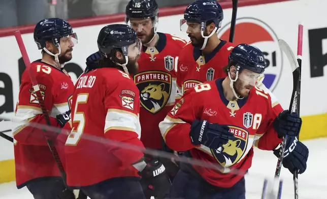 Florida Panthers' Matthew Tkachuk (19) celebrates with teammates after his goal against the Edmonton Oilers during the first period in Game 4 of the NHL hockey Stanley Cup Final in Sunrise, Fla., Thursday, June 12, 2025. (Nathan Denette/The Canadian Press via AP)