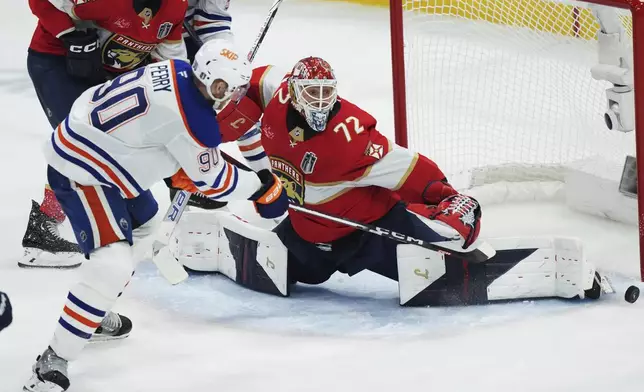 Edmonton Oilers' Corey Perry (90) is stopped by Florida Panthers goalie Sergei Bobrovsky (72) during the third period in Game 4 of the NHL hockey Stanley Cup Final in Sunrise, Fla., Thursday, June 12, 2025. (Nathan Denette/The Canadian Press via AP)